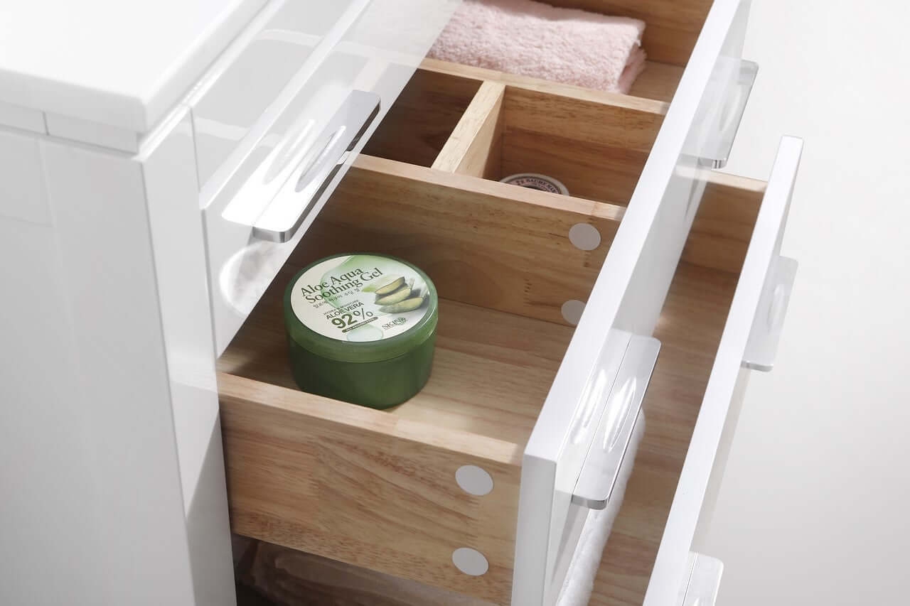 Close-up of white high gloss vanity drawers with wood interior, featuring beauty products and organized compartments.